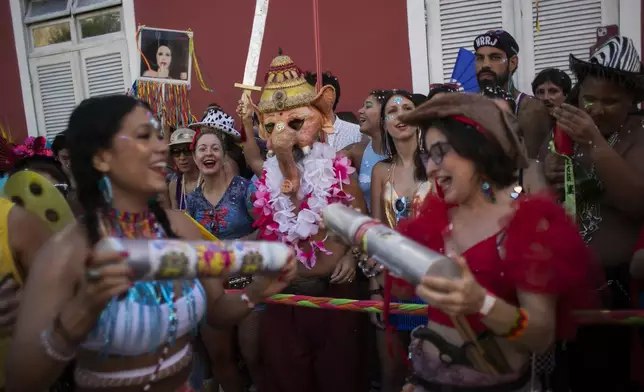 A reveler dressed as Ganesha, a Hindu deity, center, watches the "Ceu na Terra" or "Heaven on Earth" Carnival street party in Rio de Janeiro, Saturday, March 1, 2025. (AP Photo/Bruna Prado)