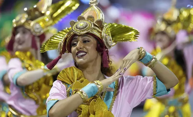 A dancer from the Colorado do Bras samba school performs during a carnival parade in Sao Paulo, Friday, Feb. 28, 2025. (AP Photo/Andre Penner)