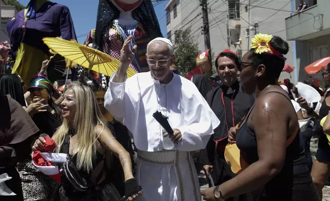 Reveler Fernando Coelho, dressed as a pope, takes part in the Carmelitas street party on the first official day of Carnival in Rio de Janeiro, Friday, Feb. 28, 2025. (AP Photo/Bruna Prado)