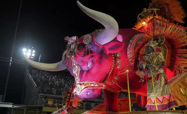A performer from the Unidos de Padre Miguel samba school dances on a float during Carnival celebrations at the Sambadrome in Rio de Janeiro, Sunday, March 2, 2025. (AP Photo/Silvia Izquierdo)