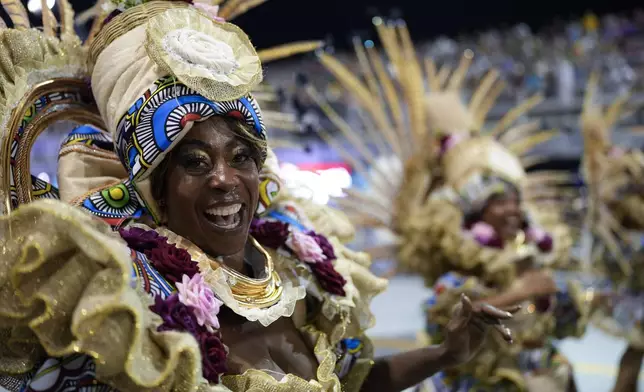 A dancer from the Colorado do Bras samba school performs during a carnival parade in Sao Paulo, Friday, Feb. 28, 2025. (AP Photo/Andre Penner)
