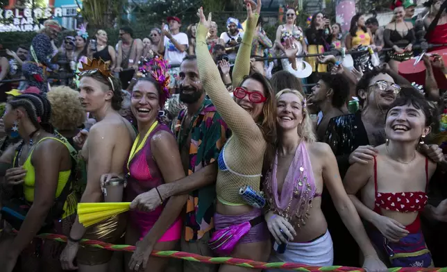 Revelers attend the "Ceu na Terra" or "Heaven on Earth" Carnival street party in Rio de Janeiro, Saturday, March 1, 2025. (AP Photo/Bruna Prado)