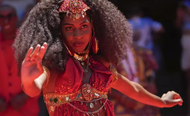 A dancer performs during the ceremony that officially kicks off Carnival in Rio de Janeiro, Brazil, Friday, Feb. 28, 2025. (AP Photo/Silvia Izquierdo)