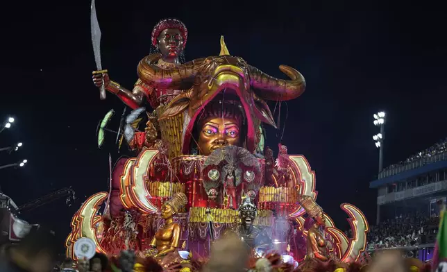 Dancers from the Barroca Zona Sul samba school perform on a float during a carnival parade in Sao Paulo, Saturday, March 1, 2025. (AP Photo/Andre Penner)