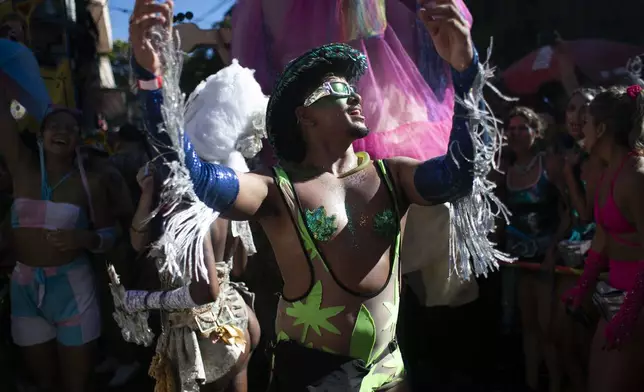 A reveler dances during the "Ceu na Terra" or "Heaven on Earth" Carnival street party in Rio de Janeiro, Saturday, March 1, 2025. (AP Photo/Bruna Prado)