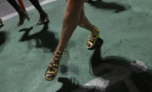 Transgender dancers with the Paraiso de Tuiuti samba school rehearse in heels for the Carnival parade in Rio de Janeiro, Monday, Feb. 17, 2025. (AP Photo/Silvia Izquierdo)