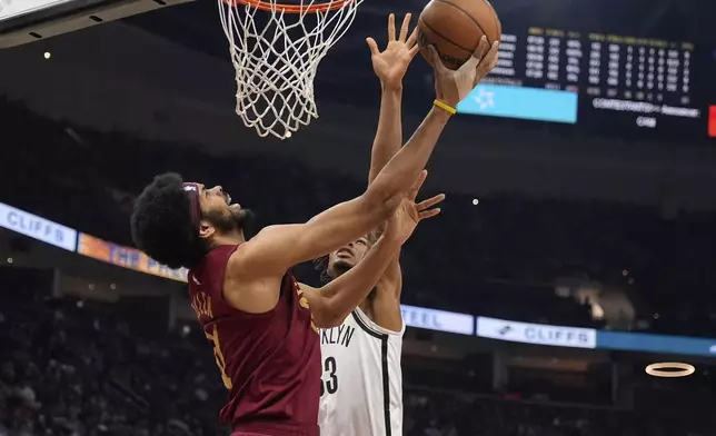 Cleveland Cavaliers center Jarrett Allen (31) shoots in front of Brooklyn Nets center Nic Claxton, right, in the first half of an NBA basketball game Tuesday, March 11, 2025, in Cleveland. (AP Photo/Sue Ogrocki)