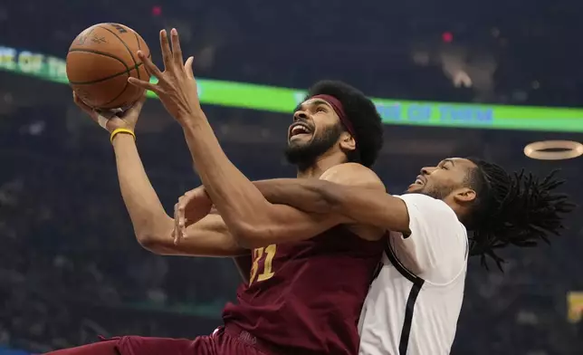 Cleveland Cavaliers center Jarrett Allen (31) is fouled by Brooklyn Nets forward Ziaire Williams, right, in the first half of an NBA basketball game Tuesday, March 11, 2025, in Cleveland. (AP Photo/Sue Ogrocki)