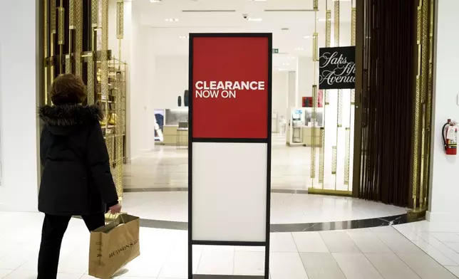 A shopper enters Saks Fifth Avenue, Canada at a Hudson's Bay in Toronto, Monday, March 17, 2025. (Christopher Katsarov/The Canadian Press via AP)