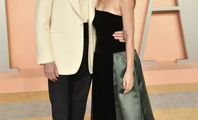 John Mulaney and Olivia Munn arrive at the Vanity Fair Oscar Party on Sunday, March 2, 2025, at the Wallis Annenberg Center for the Performing Arts in Beverly Hills, Calif. (Photo by Evan Agostini/Invision/AP)