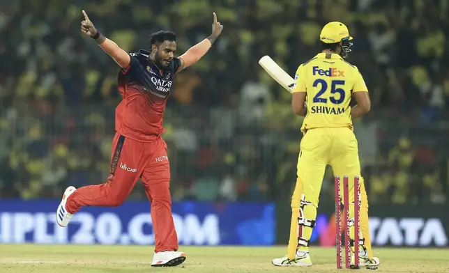 Royal Challengers Bengaluru's Yash Dayal celebrates the dismissal of Chennai Super Kings' Shivam Dube, right, during the Indian Premier League cricket match between Chennai Super Kings and Royal Challengers Bengaluru at M. A. Chidambaram Stadium in Chennai, India, Friday, March 28, 2025. (AP Photo/R. Parthibhan)