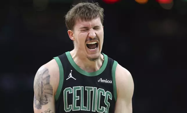 Boston Celtics' Baylor Scheierman reacts after making a 3-pointer during second half of an NBA basketball game against the Brooklyn Nets Tuesday, March 18, 2025, in Boston. (AP Photo/Michael Dwyer)