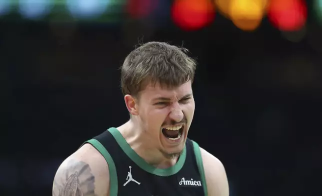 Boston Celtics' Baylor Scheierman reacts after making a 3-pointer during second half of an NBA basketball game against the Brooklyn Nets Tuesday, March 18, 2025, in Boston. (AP Photo/Michael Dwyer)