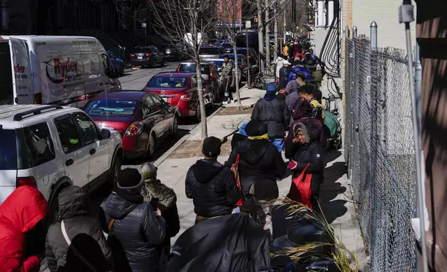 People wait in line to receive free eggs from FarmerJawn Agriculture, Friday, March 21, 2025, in the Harlem neighborhood of New York. (AP Photo/Julia Demaree Nikhinson)