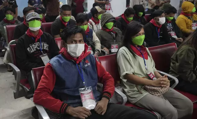 Indonesia nationals who had worked at scam centers in eastern Myanmar sit in a waiting room upon arrival from Thailand, at Soekarno-Hatta International Airport in Tangerang, Indonesia, Friday, Feb. 28, 2025.(AP Photo/Tatan Syuflana)