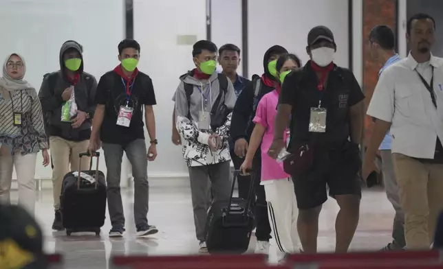 Indonesia nationals who had worked at scam centers in eastern Myanmar walk upon arrival from Thailand, at Soekarno-Hatta International Airport in Tangerang, Indonesia, Friday, Feb. 28, 2025.(AP Photo/Tatan Syuflana)