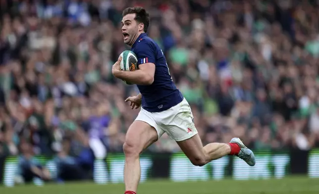 France's Damian Penaud runs to score a try during the Six Nations rugby union match between Ireland and France, at Aviva Stadium, Dublin, Ireland, Saturday, March 8, 2025. (AP Photo/Peter Morrison)