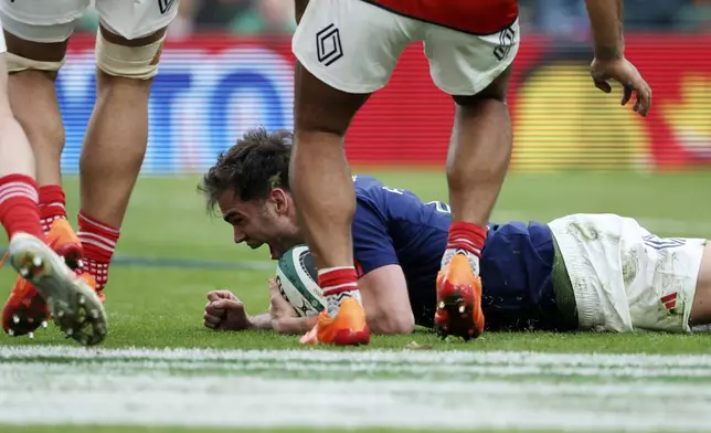 France's Damian Penaud reacts after scoring a try during the Six Nations rugby union match between Ireland and France, at Aviva Stadium, Dublin, Ireland, Saturday, March 8, 2025. (AP Photo/Peter Morrison)