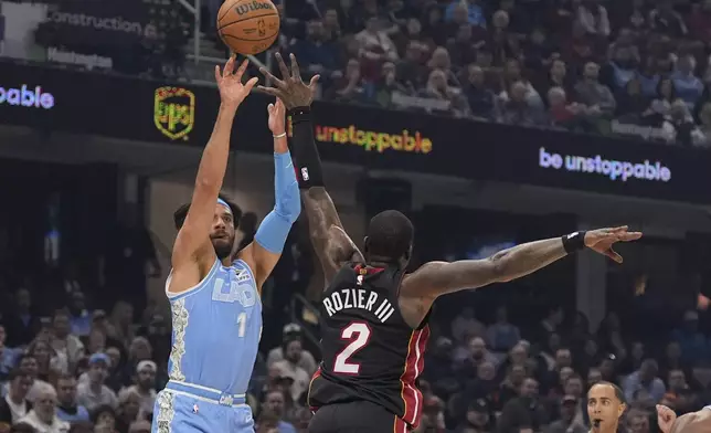 Cleveland Cavaliers guard Max Strus (1) shoots over Miami Heat guard Terry Rozier (2) in the first half of an NBA basketball game Wednesday, March 5, 2025, in Cleveland. (AP Photo/Sue Ogrocki)