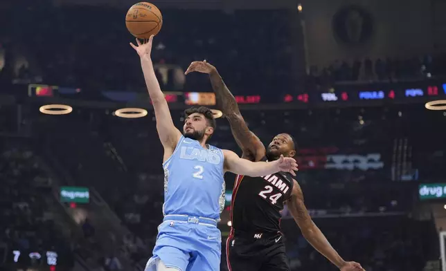 Cleveland Cavaliers guard Ty Jerome (2) shoots in front of Miami Heat forward Haywood Highsmith (24) in the first half of an NBA basketball game Wednesday, March 5, 2025, in Cleveland. (AP Photo/Sue Ogrocki)