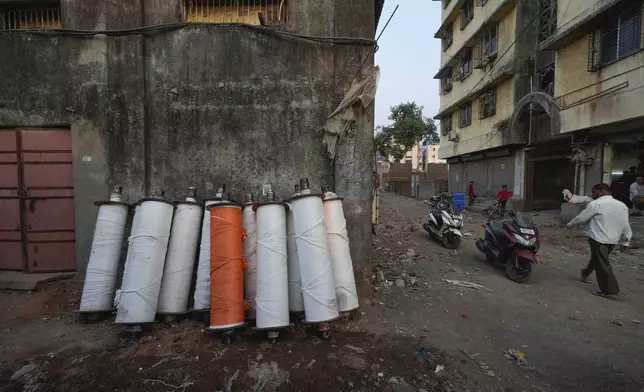 Wrapped warp beam yarns for weaving cloth on a power loom are kept outside a workshop in Bhiwandi, India, Feb. 27, 2025. (AP Photo/Rafiq Maqbool)