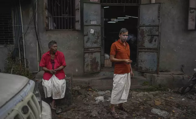 Workers relax during lunch break at a power loom workshop in Bhiwandi, India, Feb. 27, 2025. (AP Photo/Rafiq Maqbool)