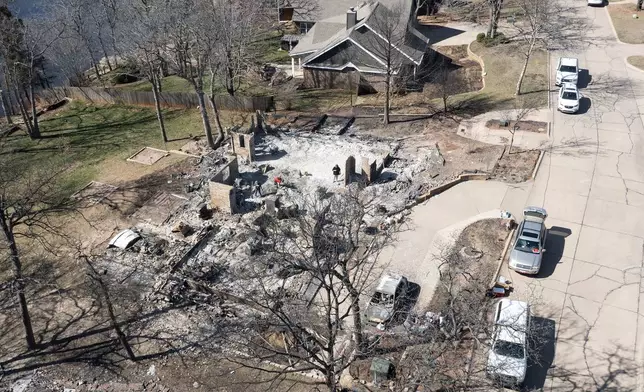 An aerial view of Andrine Shufran's burned home in the Hidden Oaks neighborhood in Stillwater, Okla., Monday, March 17, 2025, after wildfires burned through the area Friday. (AP Photo/Alonzo Adams)