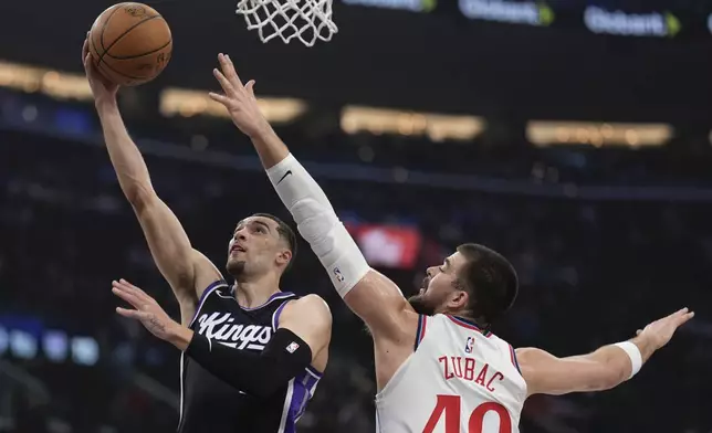 Sacramento Kings guard Zach LaVine, left, shoots as Los Angeles Clippers center Ivica Zubac defends during the first half of an NBA basketball game Sunday, March 9, 2025, in Inglewood, Calif. (AP Photo/Mark J. Terrill)