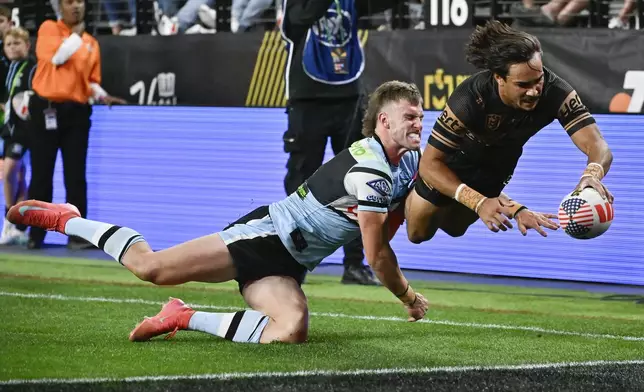 Penrith Panthers Daine Laurie dives across the line to score a try during Australia's National Rugby League game between the Penrith Panthers and Cronulla Sutherland-Sharks at Allegiant Stadium in Las Vegas, Saturday, March 1, 2025. (AP Photo/David Becker)