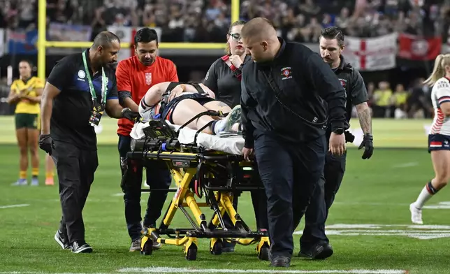 England's Vicky Whitfield is taken from the field on a stretcher following a collision during the rugby league international between Australia's Jillaroos and England at Allegiant Stadium in Las Vegas, Saturday, March 1, 2025. (AP Photo/David Becker)
