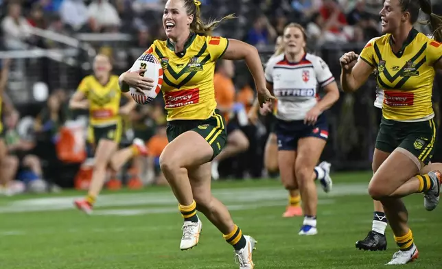 Australian Jillaroo Keilee Joseph reacts as she runs to score a try during the rugby league international between Australia's Jillaroos and England at Allegiant Stadium in Las Vegas, Saturday, March 1, 2025. (AP Photo/David Becker)