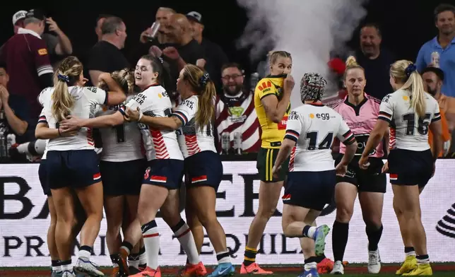 England players congratulate Georgia Roche after she scored a try during the rugby league international between Australia's Jillaroos and England at Allegiant Stadium in Las Vegas, Saturday, March 1, 2025. (AP Photo/David Becker)