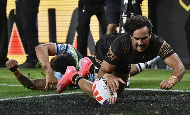 Penrith Panthers Daine Laurie scores a try during Australia's National Rugby League game between the Penrith Panthers and Cronulla Sutherland-Sharks at Allegiant Stadium in Las Vegas, Saturday, March 1, 2025. (AP Photo/David Becker)