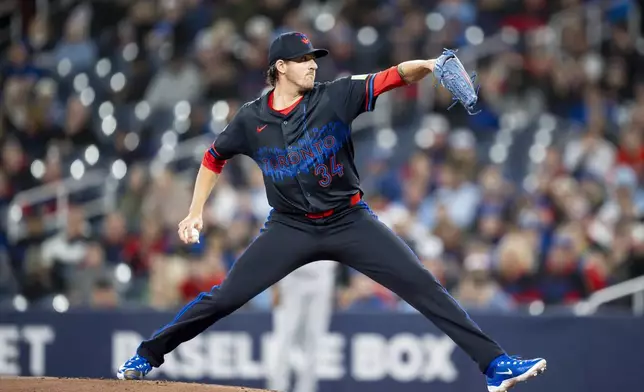 Toronto Blue Jays pitcher Kevin Gausman works against the Baltimore Orioles during first-inning baseball game action in Toronto, Friday, March 28, 2025. (Christopher Katsarov/The Canadian Press via AP)