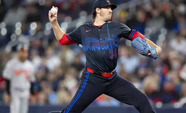 Toronto Blue Jays pitcher Kevin Gausman works against the Baltimore Orioles during first-inning baseball game action in Toronto, Friday, March 28, 2025. (Christopher Katsarov/The Canadian Press via AP)