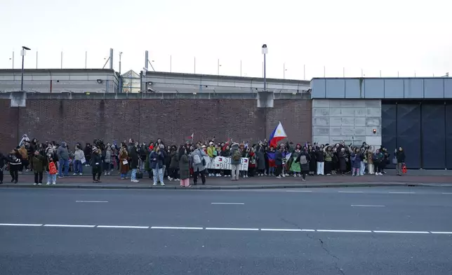 Supporters of former Philippine President Rodrigo Duterte hold flags and banners during a demonstration outside the International Criminal Court detention center near The Hague in Scheveningen, Netherlands, Wednesday, March 12, 2025. (AP Photo/Omar Havana)