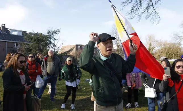 A supporter of former Philippine President Rodrigo Duterte waves a flag as he demonstrates outside the International Criminal Court detention center near The Hague in Scheveningen, Netherlands, Wednesday, March 12, 2025. (AP Photo/Omar Havana)