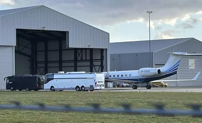 A plane believed to be carrying former Philippine President Rodrigo Duterte is parked next to a bus at Rotterdam The Hague Airport in the Netherlands, Wednesday, March 12, 2025. (AP Photo/Mark Carlson)