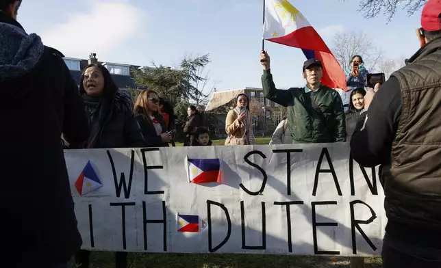 A supporter of former Philippine President Rodrigo Duterte waves a flag as he demonstrates outside the International Criminal Court detention center near The Hague in Scheveningen, Netherlands, Wednesday, March 12, 2025. (AP Photo/Omar Havana)