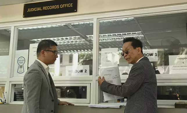 Salvador Panelo, former presidential spokesman and chief presidential legal counsel of Philippine former President Rodrigo Duterte, shows a copy of the Habeas Corpus petition after filing it at the Supreme Court on Wednesday, March 11, 2025 in Manila, Philippines. (AP Photo/Noel Celis)