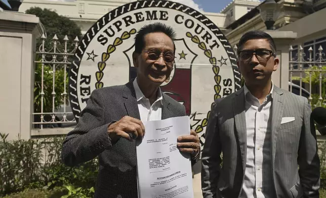 Salvador Panelo, former presidential spokesman and chief presidential legal counsel of Philippine former President Rodrigo Duterte, shows a copy of the Habeas Corpus petition before filing it at the Supreme Court on Wednesday, March 11, 2025 in Manila, Philippines (AP Photo/Noel Celis)