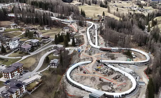 Construction work takes place at the Cortina Sliding Center, venue for the bob, luge and skeleton disciplines at the Milan Cortina 2026 Winter Olympics, in Cortina D'Ampezzo, Italy, Tuesday, March 25, 2025. (AP Photo/Luca Bruno)