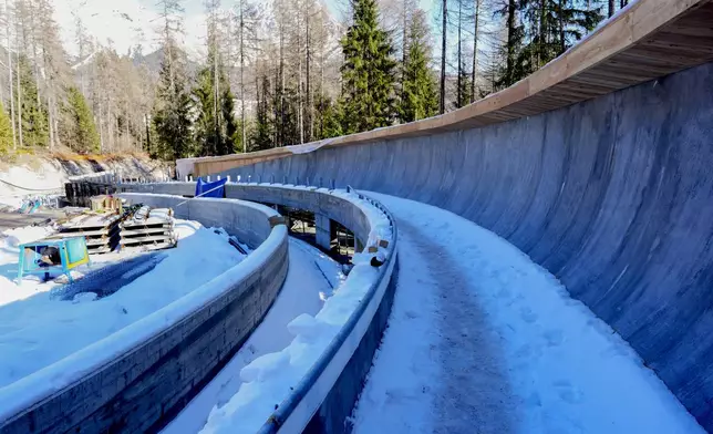 FILE - Construction work takes place at the Cortina Sliding Center, venue for the bob, luge and skeleton disciplines at the Milan Cortina 2026 Winter Olympics, in Cortina d'Ampezzo, Italy, Thursday, Jan. 16, 2025. (AP Photo/Giovanni Auletta, file)