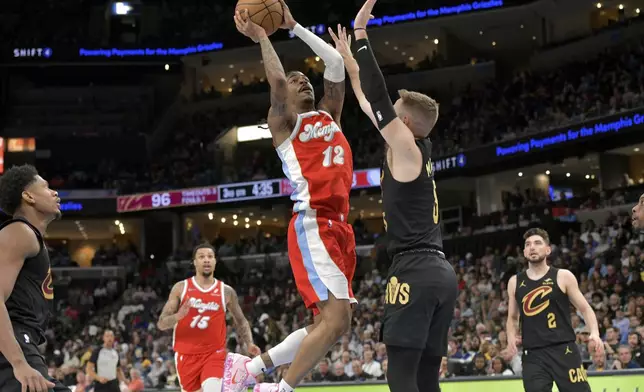 Memphis Grizzlies guard Ja Morant (12) shoots against Cleveland Cavaliers guard Sam Merrill (5) in the second half of an NBA basketball game Friday, March 14, 2025, in Memphis, Tenn. (AP Photo/Brandon Dill)