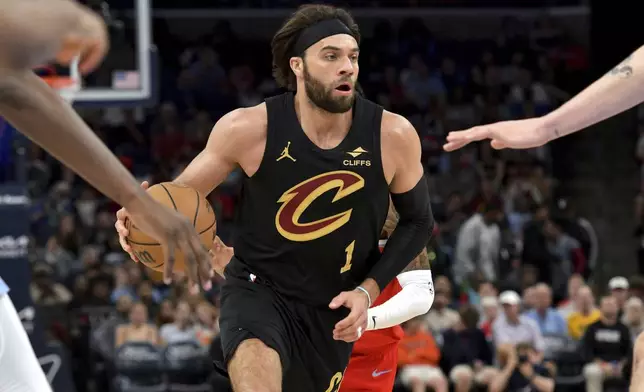 Cleveland Cavaliers guard Max Strus (1) handles the ball against the Memphis Grizzlies in the first half of an NBA basketball game Friday, March 14, 2025, in Memphis, Tenn. (AP Photo/Brandon Dill)