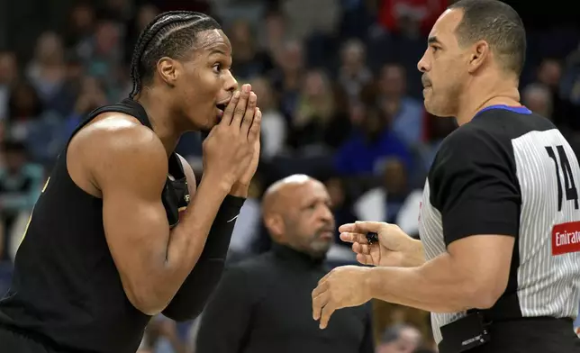 Cleveland Cavaliers forward Isaac Okoro, left, reacts to a call by referee Curtis Blair (74) in the first half of an NBA basketball game against the Memphis Grizzlies, Friday, March 14, 2025, in Memphis, Tenn. (AP Photo/Brandon Dill)