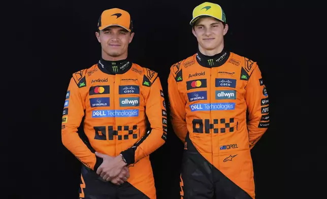 McLaren driver Oscar Piastri, right, of Australia and teammate Lando Norris of Britain pose for the drivers portrait photo session ahead of the Australian Formula One Grand Prix at Albert Park, in Melbourne, Australia, Thursday, March 13, 2025. (AP Photo/Asanka Brendon Ratnayake)