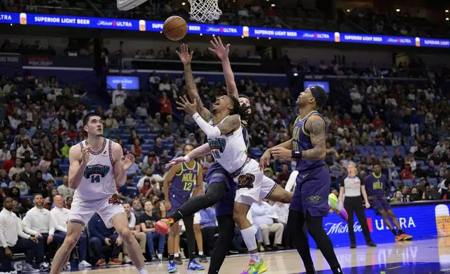 Memphis Grizzlies guard Ja Morant (12) shoots against New Orleans Pelicans center Karlo Matkovic (17) drawing a foul during the first half of an NBA basketball game in New Orleans, Sunday, March 9, 2025. (AP Photo/Matthew Hinton)