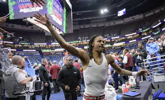 Memphis Grizzlies guard Ja Morant (12) runs off the court after an NBA basketball game against the New Orleans Pelicans in New Orleans, Sunday, March 9, 2025. (AP Photo/Matthew Hinton)