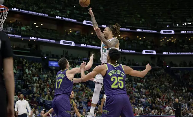 Memphis Grizzlies forward Brandon Clarke (15) shoots against New Orleans Pelicans center Karlo Matkovic (17) and guard Trey Murphy III (25) during the first half of an NBA basketball game in New Orleans, Sunday, March 9, 2025. (AP Photo/Matthew Hinton)
